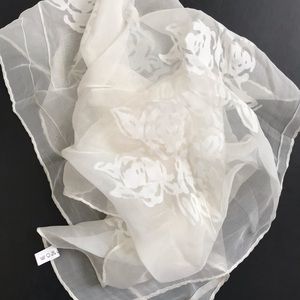 White silk shall scarf with rose patterns.